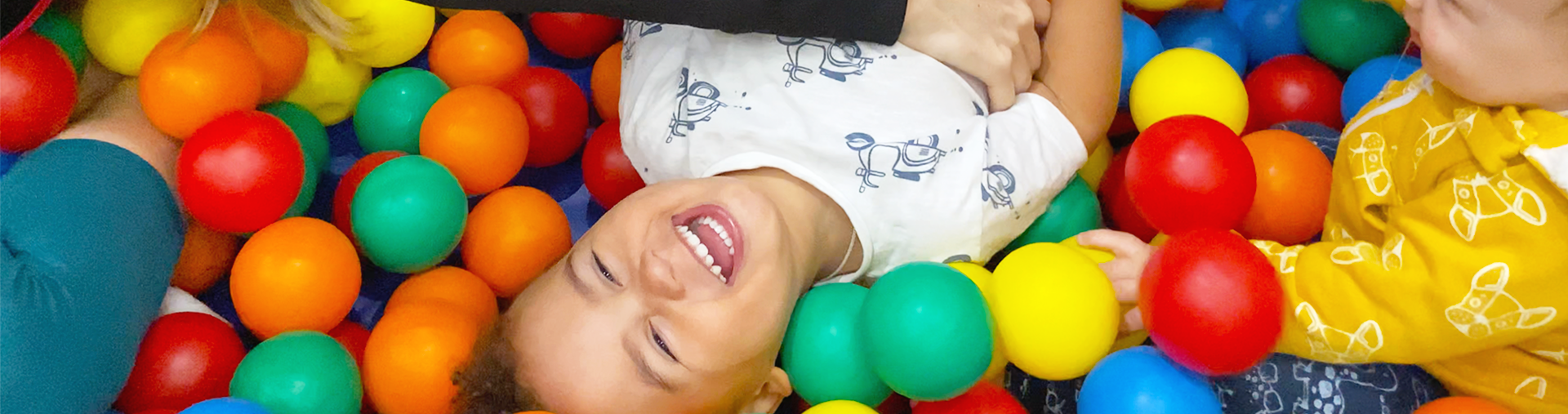 Little boy playing in ball pit 