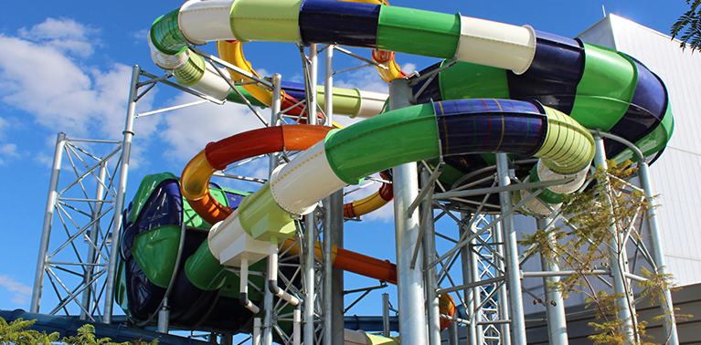 A view of the three colourful waterslides from the outside