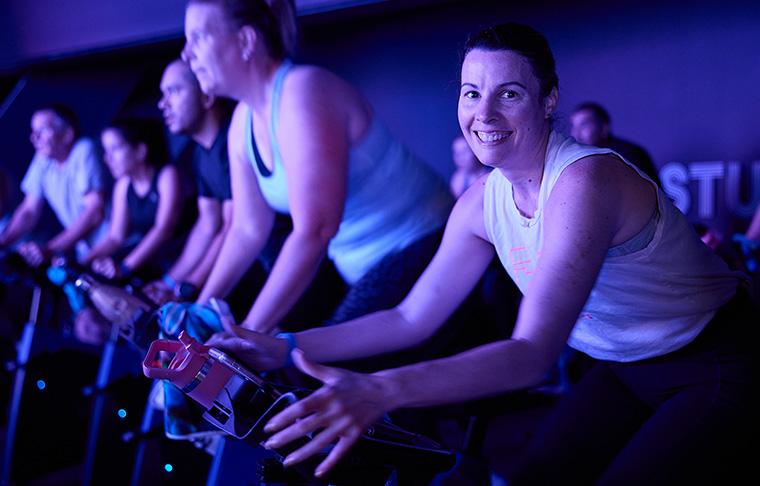 Woman exercising on bike in cycle studio
