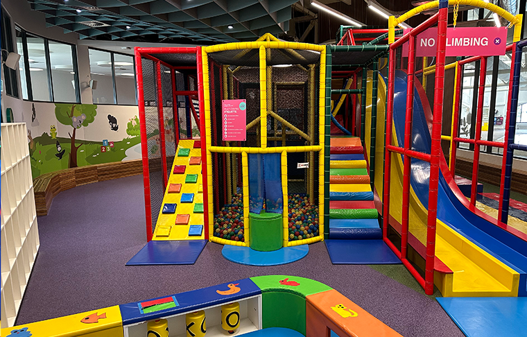 Empty play centre with colourful slides and climbing racks