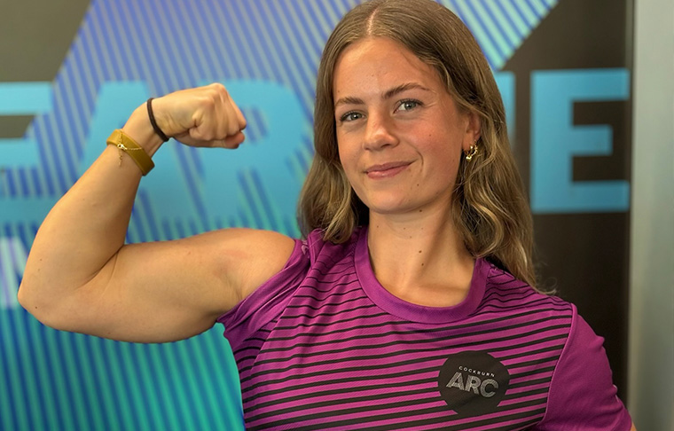 Female Personal Trainer flexing bicep