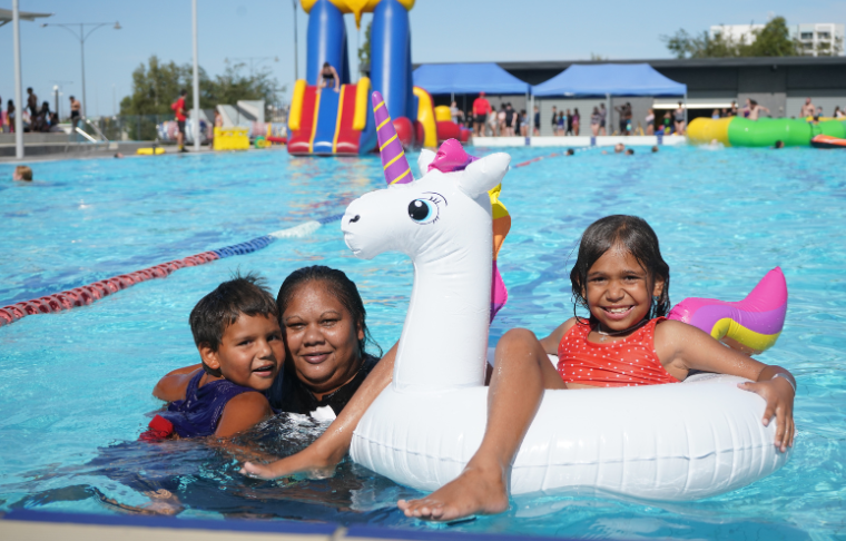 Family in the pool with floaties