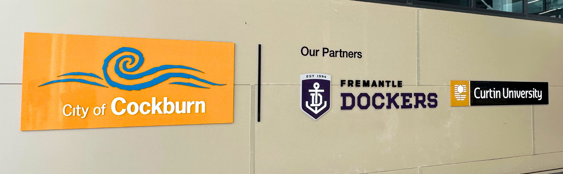 key partner signs on a wall: Fremantle Football Club & Curtin University
