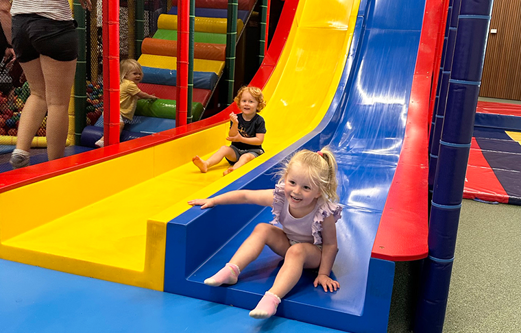 2 children go down a slide