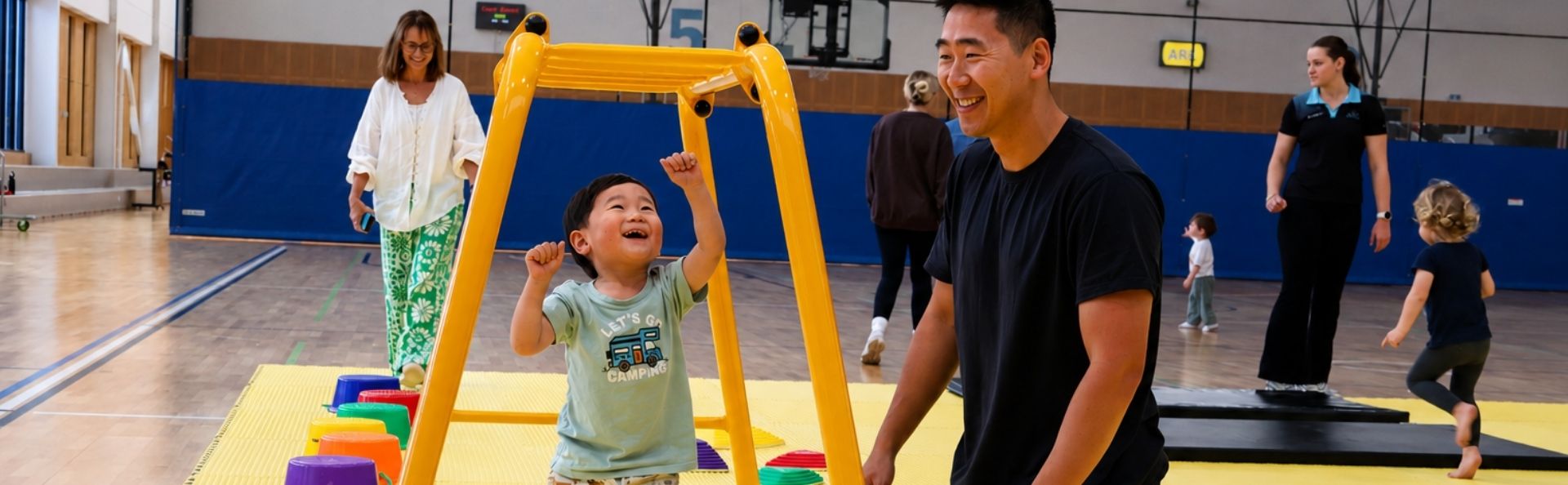 Father watching his son play on monkey bars