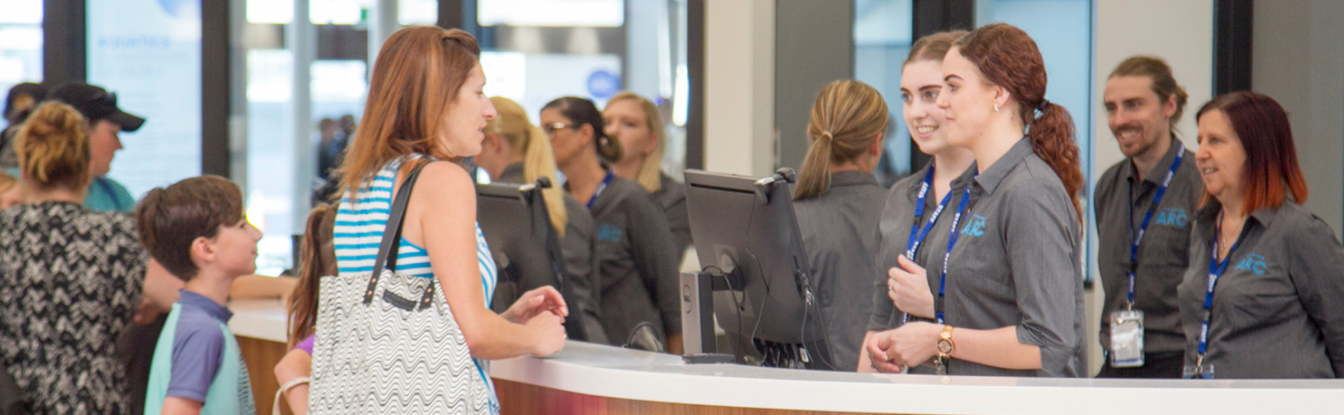 Staff helping patrons at reception