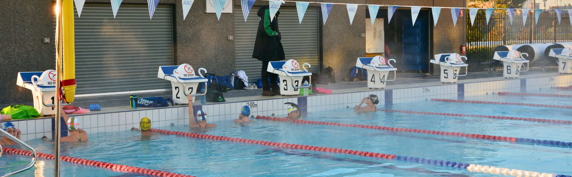Swimmers getting ready in their lanes