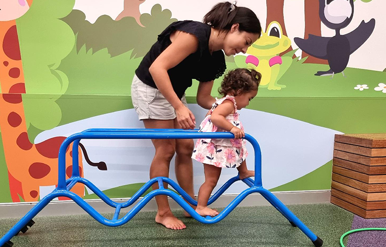 Mum and child climbing through an exercise