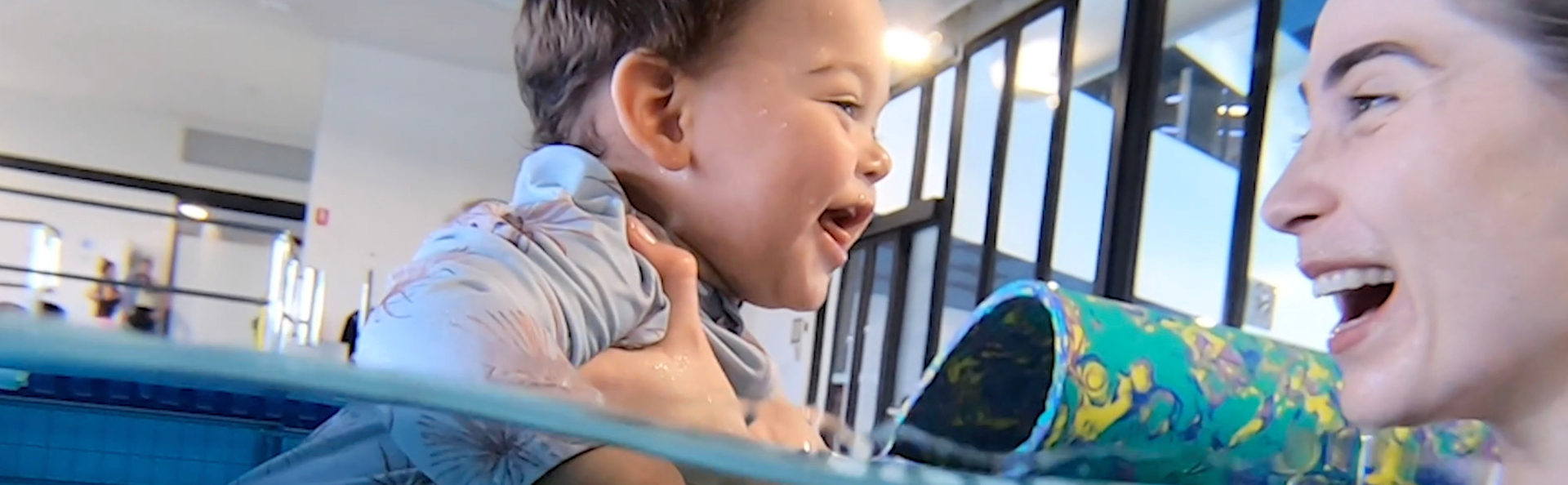Mum and baby swimming in the water