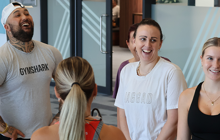 Members in group fitness laughing 