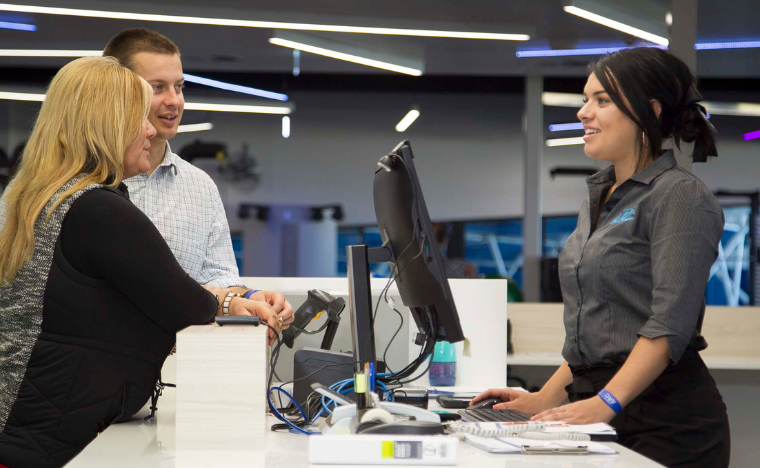 staff helping patrons at reception.
