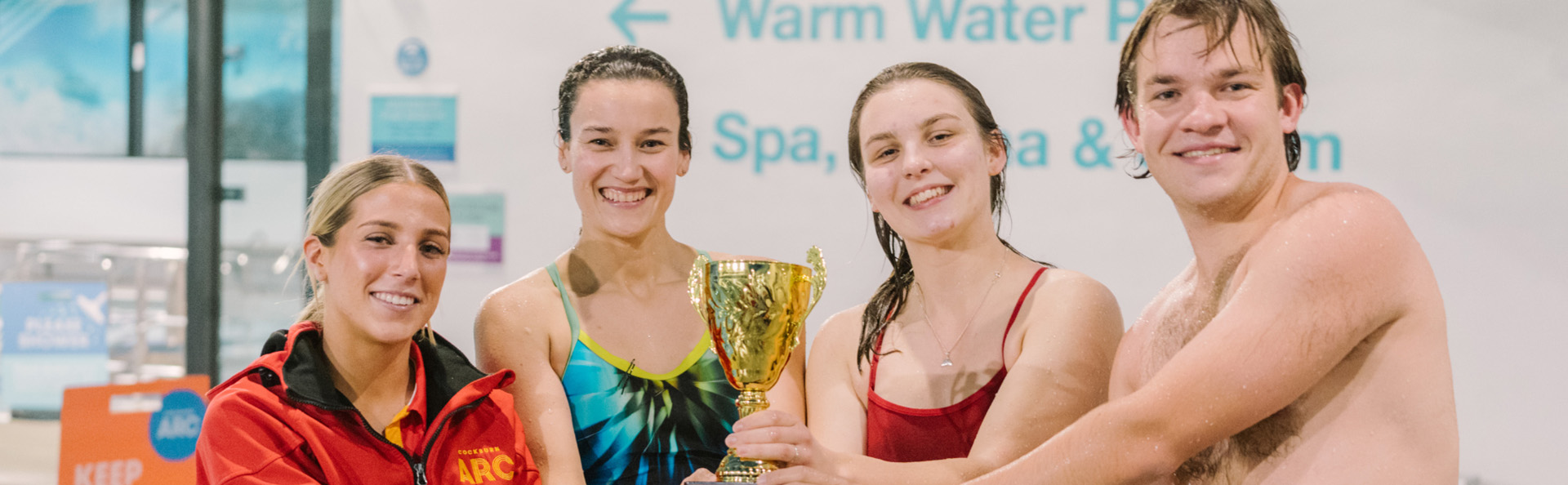 swimmers holding a trophy