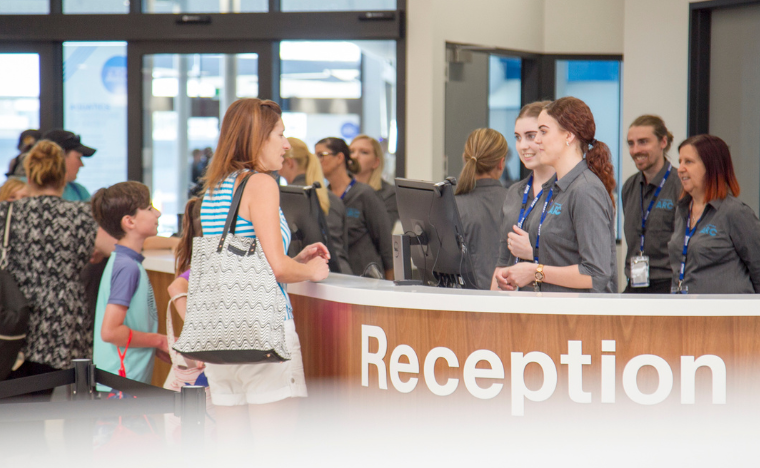 Patrons talking to the main reception desk. 
