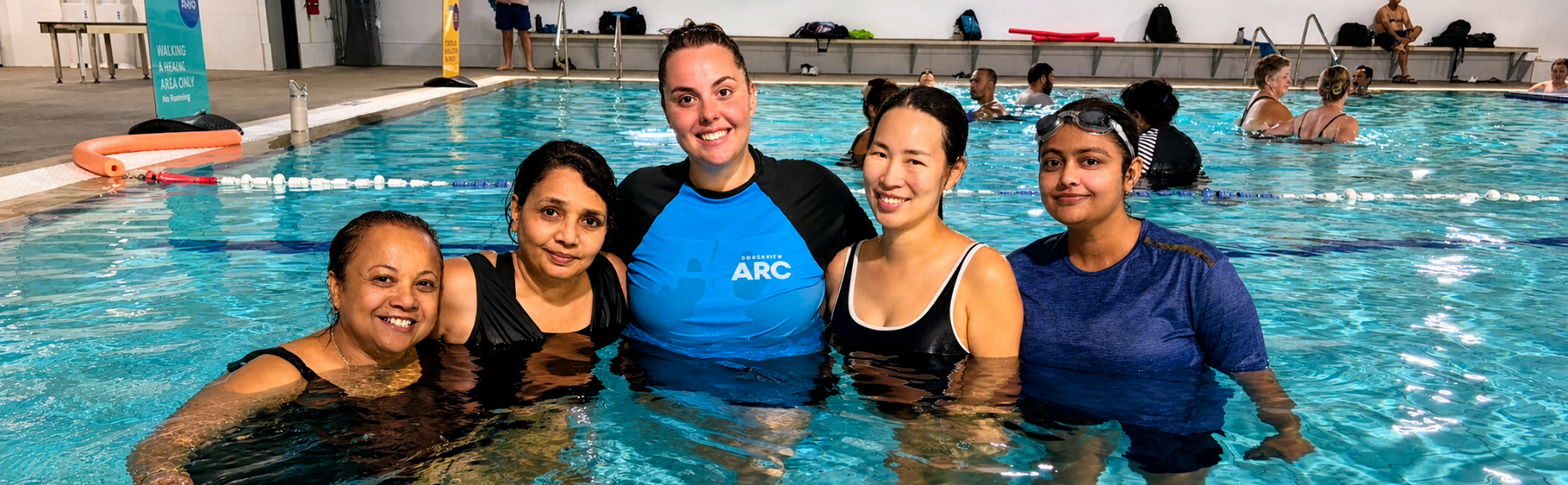 Multicultural ladies in the water with their swim instructor