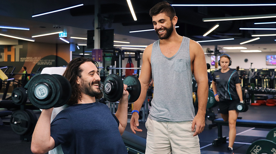 two men lifting weights