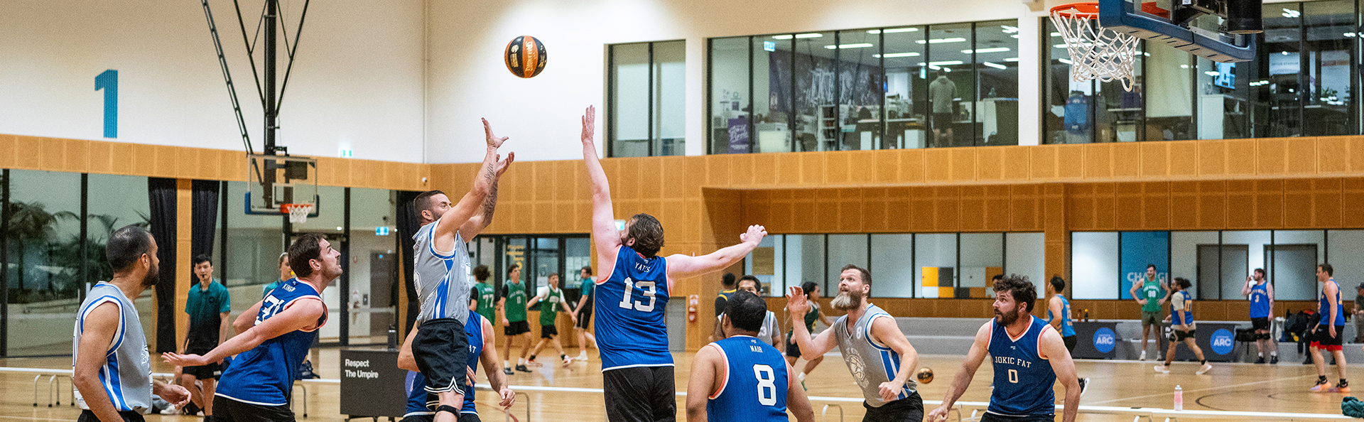 Photo of Men playing basketball in the stadium