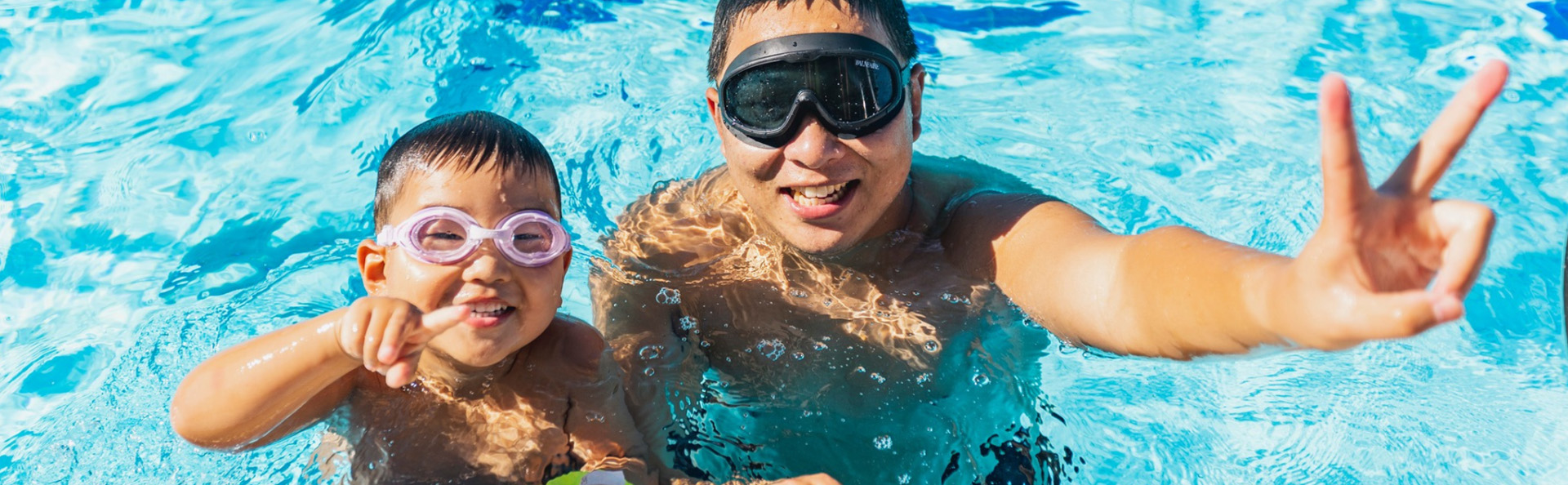 people swimming in the water, waving 