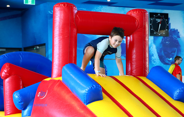 Child plays on obstacle inflatable