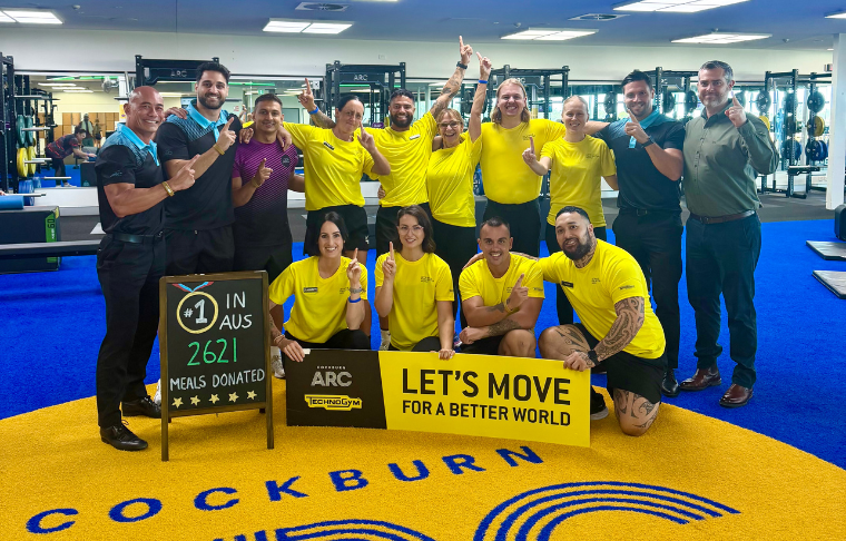 Group of people smiling and holding up some lets move signs.