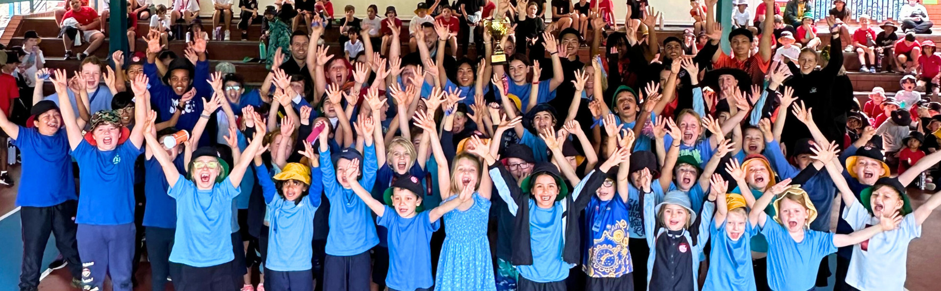 school kids celebrating with hands in the air