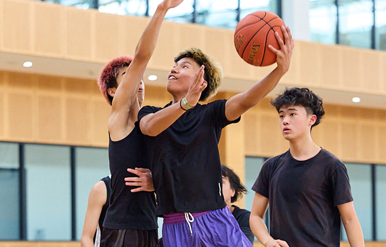 young men playing basketball 